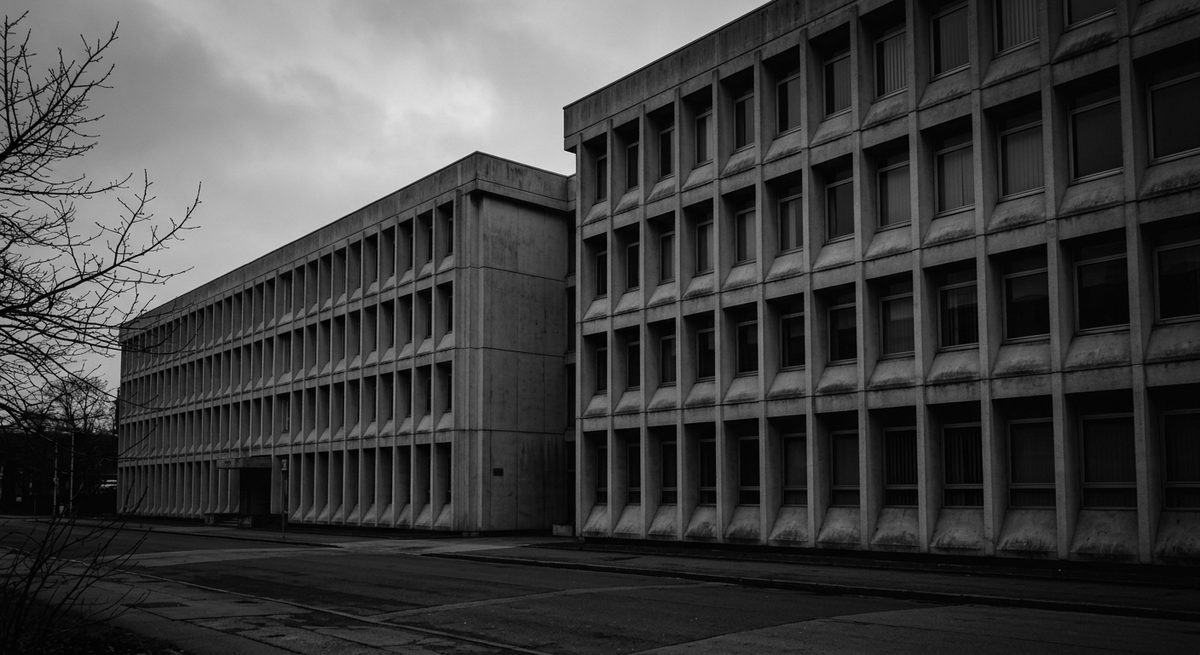 Two adjoining institutional buildings seen from street level.